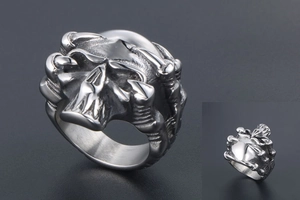 Detailed view of punk style skull ring with dragon claw skeleton in vintage steel finish