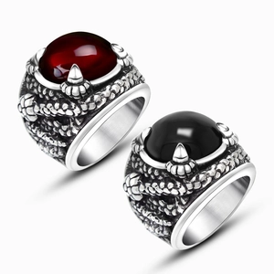 Detailed view of gothic dragon claw rings with red and black oval zircon stones