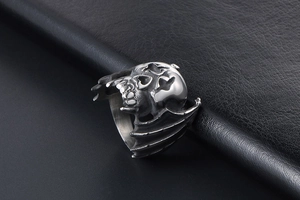 Macro shot of vintage skull and bat wings ring with aged silver finish in punk style