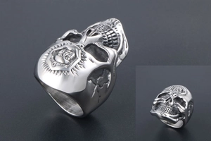 Macro detail of retro punk skull ring with weathered finish and shield crest engraving