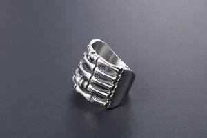 Detailed view of punk style titanium steel ring with realistic skeleton hand design