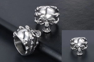 Macro shot of vintage punk skull rings with detailed dragon claw in silver titanium steel