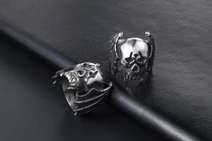 Detailed view of vintage punk skull ring with bat wings in antique silver steel finish