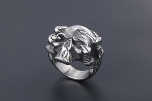 Macro detail of gothic skull ring with polished stainless steel bone and claw features