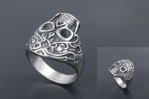 Macro detail of retro punk skull ring featuring intricate vintage silver carvings