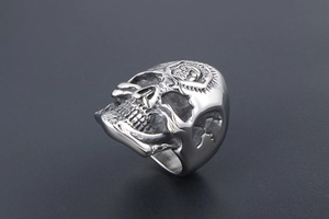 Macro shot of punk skull ring showing detailed metal carving and gothic forehead relief