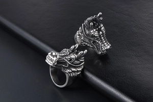 Close-up of vintage dragon head ring featuring detailed scales and punk style metalwork