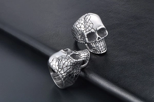 Detailed view of punk skull rings with half-smooth and half-textured mesh finish