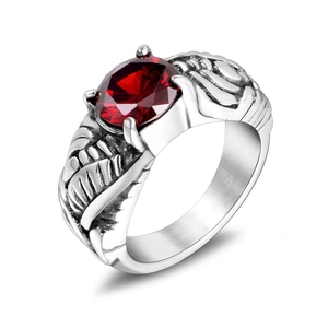 Gothic wing ring in silver finish featuring a large round faceted red gemstone center