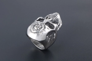 Macro shot of punk skull ring with embossed shield detail and vintage silver finish