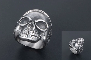 Macro shot of retro stainless steel skull ring with vintage distressed punk metal finish