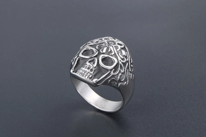 Close-up of gothic punk skull ring in silver stainless steel with embossed carving