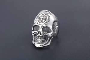 Detailed macro shot of vintage punk skull ring with sun pattern engraving in titanium steel