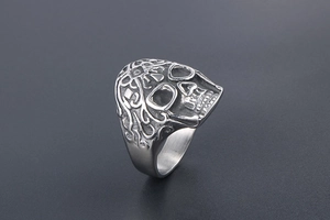 Macro side view of gothic skull ring in vintage matte steel with detailed side engravings