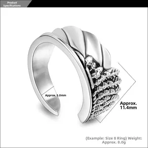 Macro view of angel wing ring showing engraved texture and specific width measurements