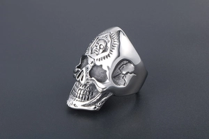 Close-up of gothic skull ring in titanium steel featuring intricate carved relief detail