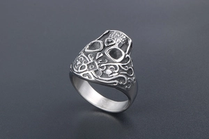 Detailed relief of punk skull and ornate scroll patterns on silver titanium steel ring