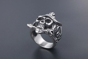 Close-up of vintage silver pirate skull ring with detailed gothic engraving on stainless steel