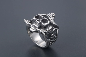 Detailed view of punk pirate skull ring with crossbones and saber in vintage silver steel