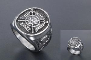 Detailed relief showing cross crown emblem and Latin inscription on vintage ring