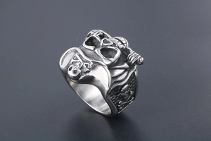 Macro side view of vintage stainless steel skull pirate ring with detailed punk carving