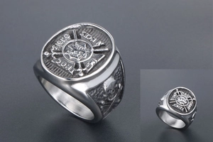 Macro detail of silver vintage ring with cross shield and skull engraving details