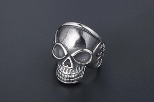 Detailed close-up of retro titanium steel skull ring with vintage distressed finish