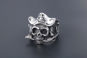 Macro view of vintage silver pirate skull ring with crossbones hat and dagger detail