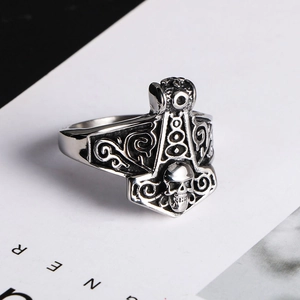 Macro detail of vintage silver Viking skull ring with Mjölnir hammer engraving