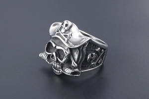 Detailed close-up of a vintage pirate skull ring with heavy relief in stainless steel