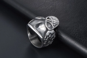 Detail of vintage skull ring with cross relief in antique silver finish on black leather