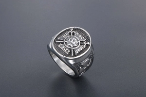 Detail view of punk anchor skull signet ring with vintage Latin inscription and cross symbols
