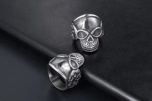 Macro shot of vintage skull ring with detailed engravings on black leather background
