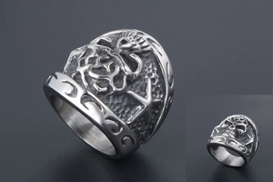 Macro shot of gothic steel ring with embossed skull, starfish, and rock textures