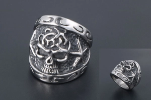 Close-up detail of gothic skull relief on vintage silver punk stainless steel ring