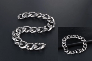 Macro view of gothic snake scale texture on a vintage silver steel chain bracelet