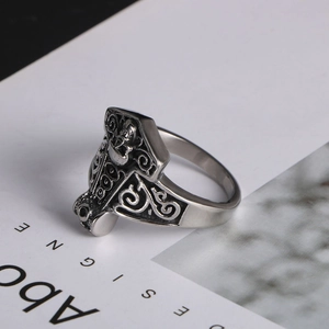 Macro detail of vintage Thor's Hammer ring with intricate Viking Celtic knot patterns