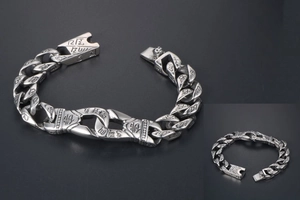 Close-up of vintage punk bracelet with engraved Buddha characters and Sanskrit patterns