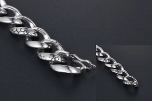 Detailed macro view of gothic snake scale pattern on polished silver steel chain link bracelet