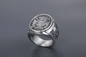 Macro shot of vintage titanium steel signet ring with skull and HOC SIGNO VINCES engraving