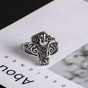 Detailed close-up of a Gothic skull crest ring with vintage silver floral engravings