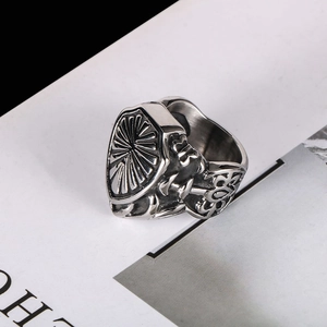 Detailed close-up of retro stainless steel shield ring with cross engravings on the side