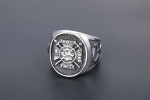 Macro view of vintage stainless steel signet ring with Latin HOC SIGNO VINCES engraving