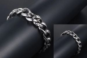 Macro detail of gothic style stainless steel bracelet showing snake scale textures