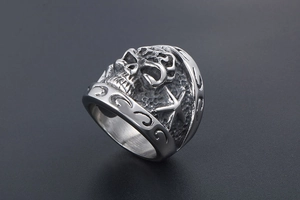 Detail of gothic stainless steel ring with 3D skull and relief star carving