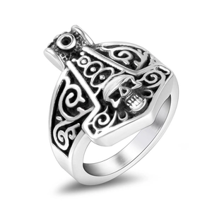 Detailed view of Viking Mjölnir ring with skull relief and vintage oxidized steel texture