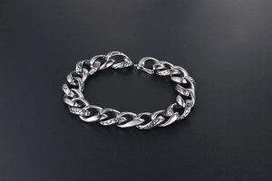 Detailed view of punk style snake skin texture on vintage stainless steel cuban chain link