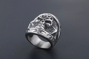 Macro shot of punk style skull ring with embossed floral side details in titanium steel
