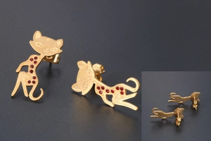 Detailed close-up of cat-shaped rose gold stud earrings with sparkling red rhinestones
