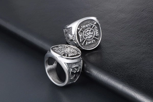 Macro detail of vintage stainless steel signet ring with engraved double sword emblem